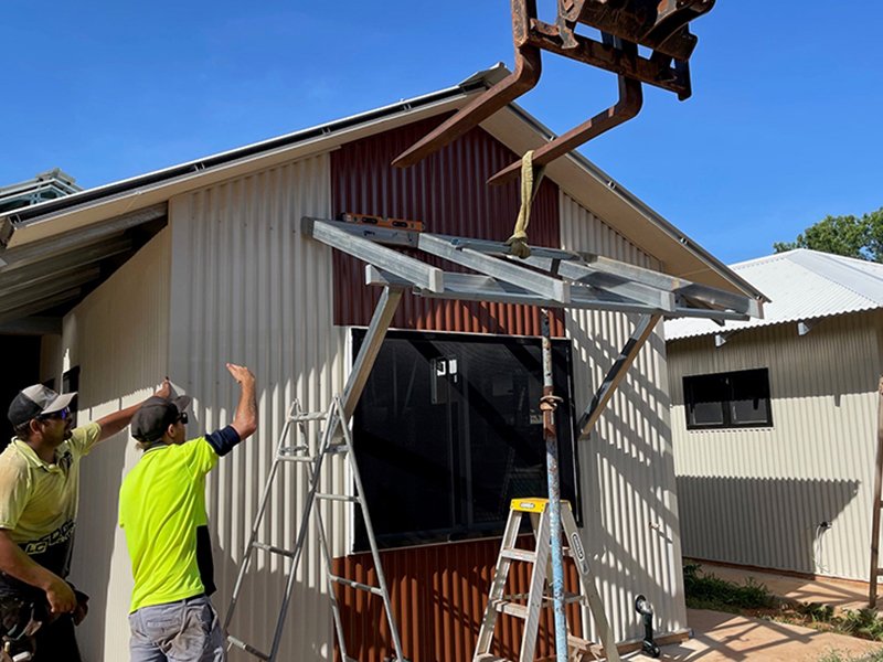 Adding the finishing touches to the Mistletoe Housing Project.