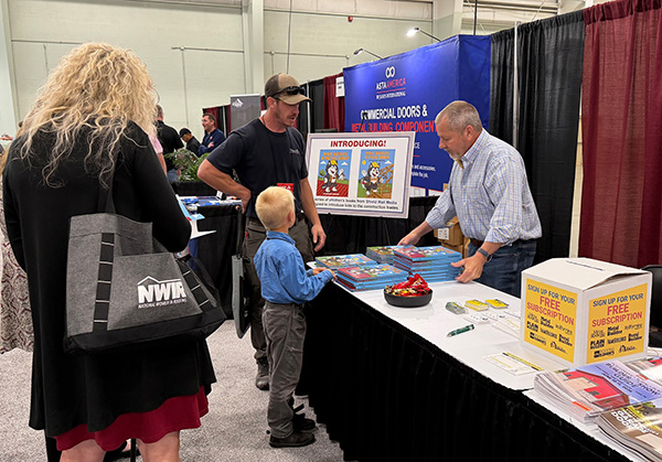 Gary_Reichert_at_left_discusses-distributes_childrens_books