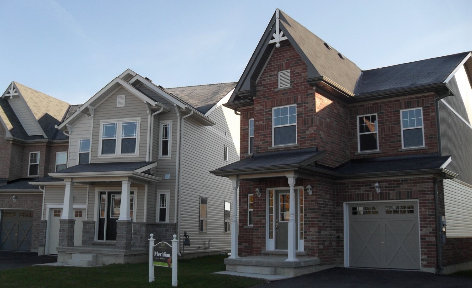 Assortment of light steel framing residential houses in a suburban neighbourhood in Canada.